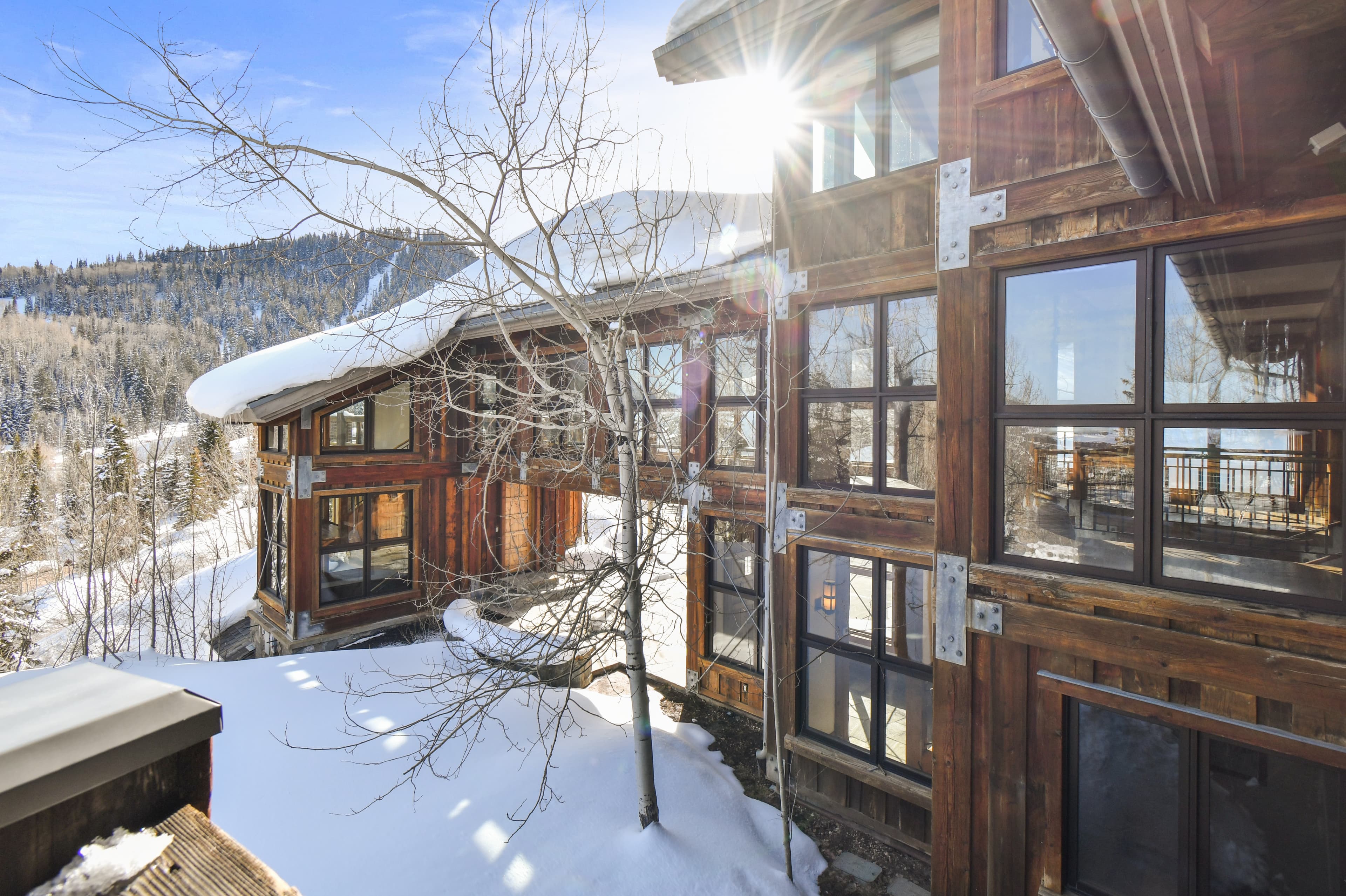 The snow covered, windowed facade of this luxury Park City vacation rental.