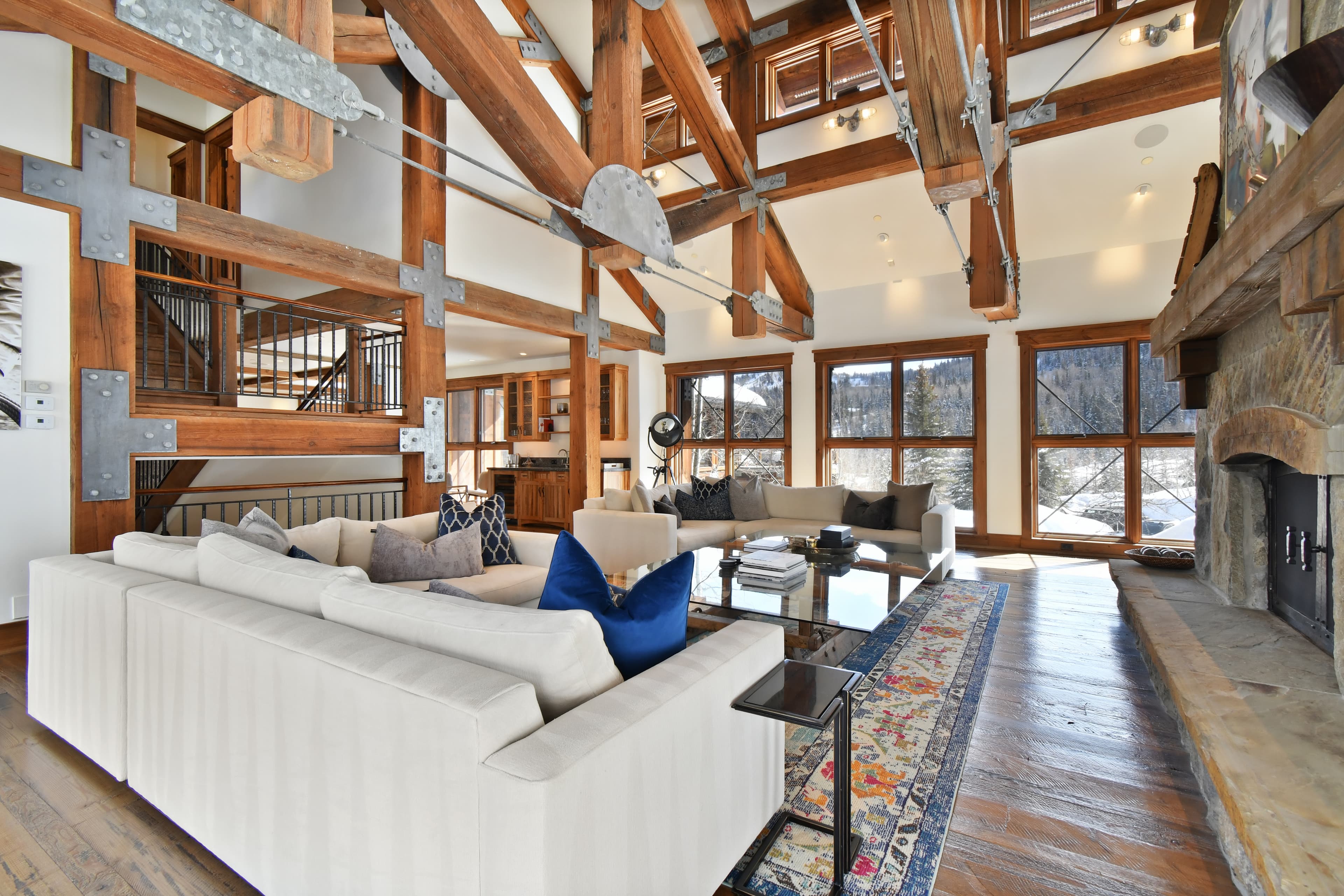 A view of the back of the living area couches, showing off exposed wooden room beams.