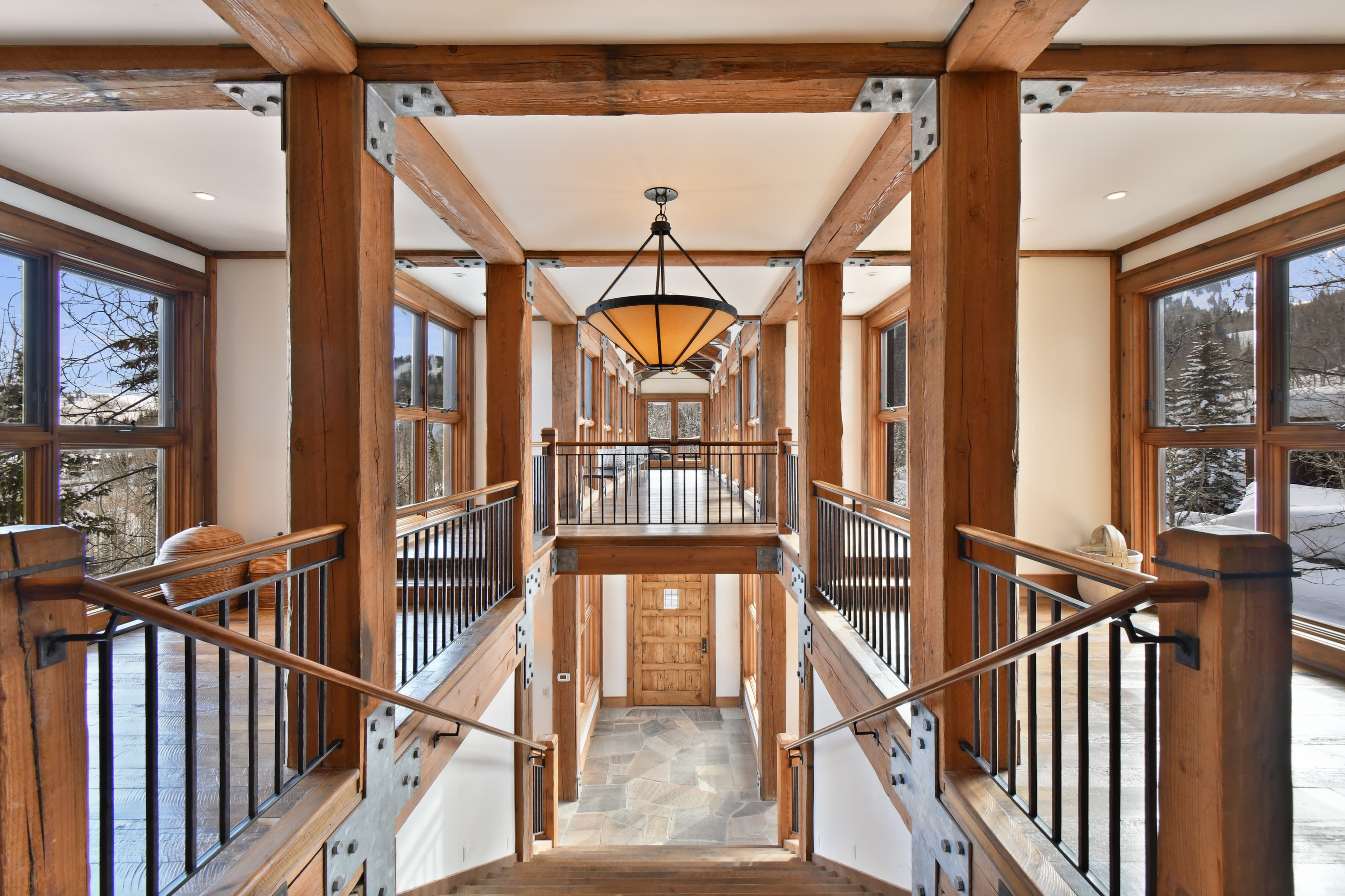 A look down the stairs leading to the entryway of the home, as taken from the upper floor.