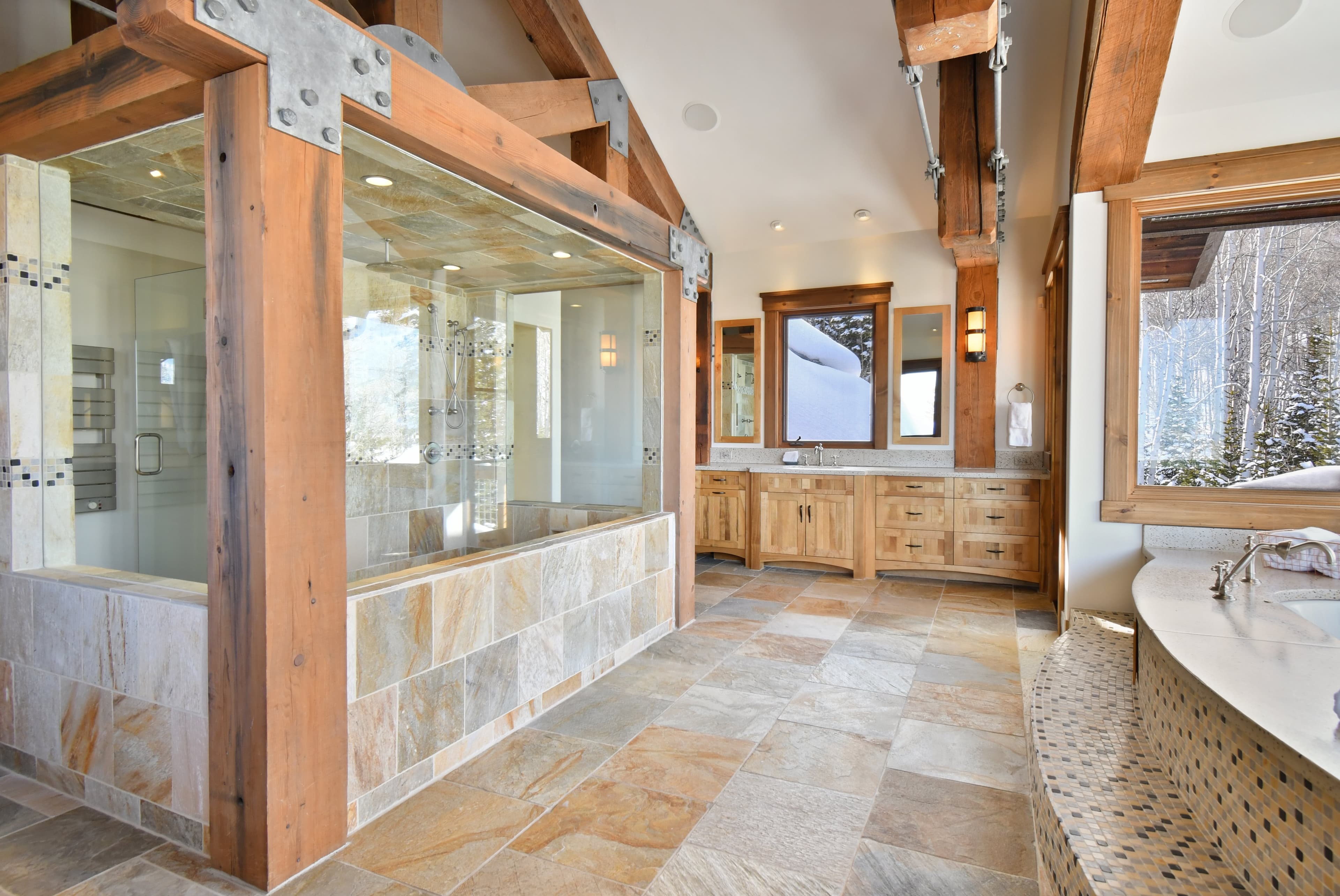 The en-suite bath of the primary bedroom, with a large walk-in shower structure in the middle.