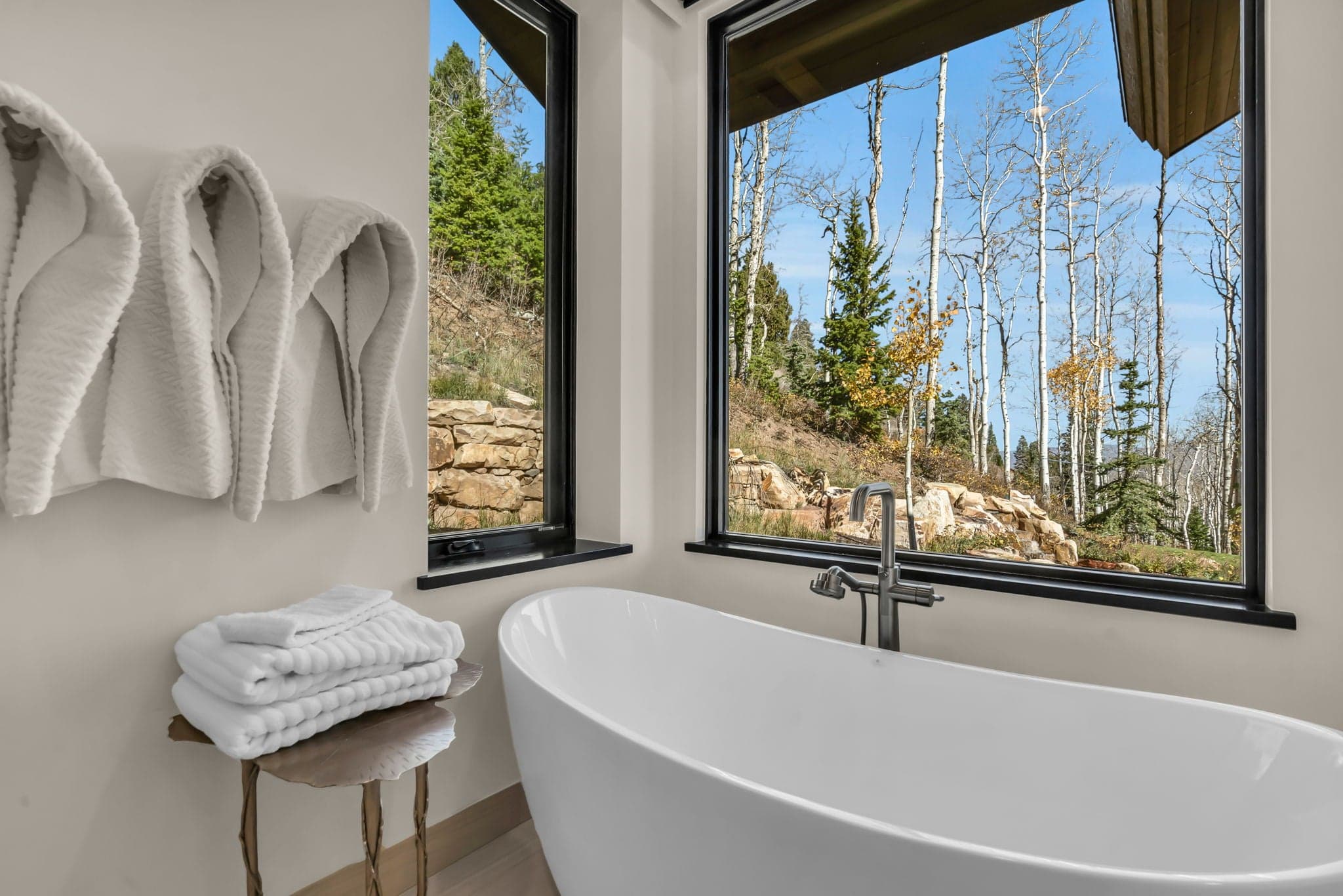 Bathtub Next to a Window with a View of the Mountains
