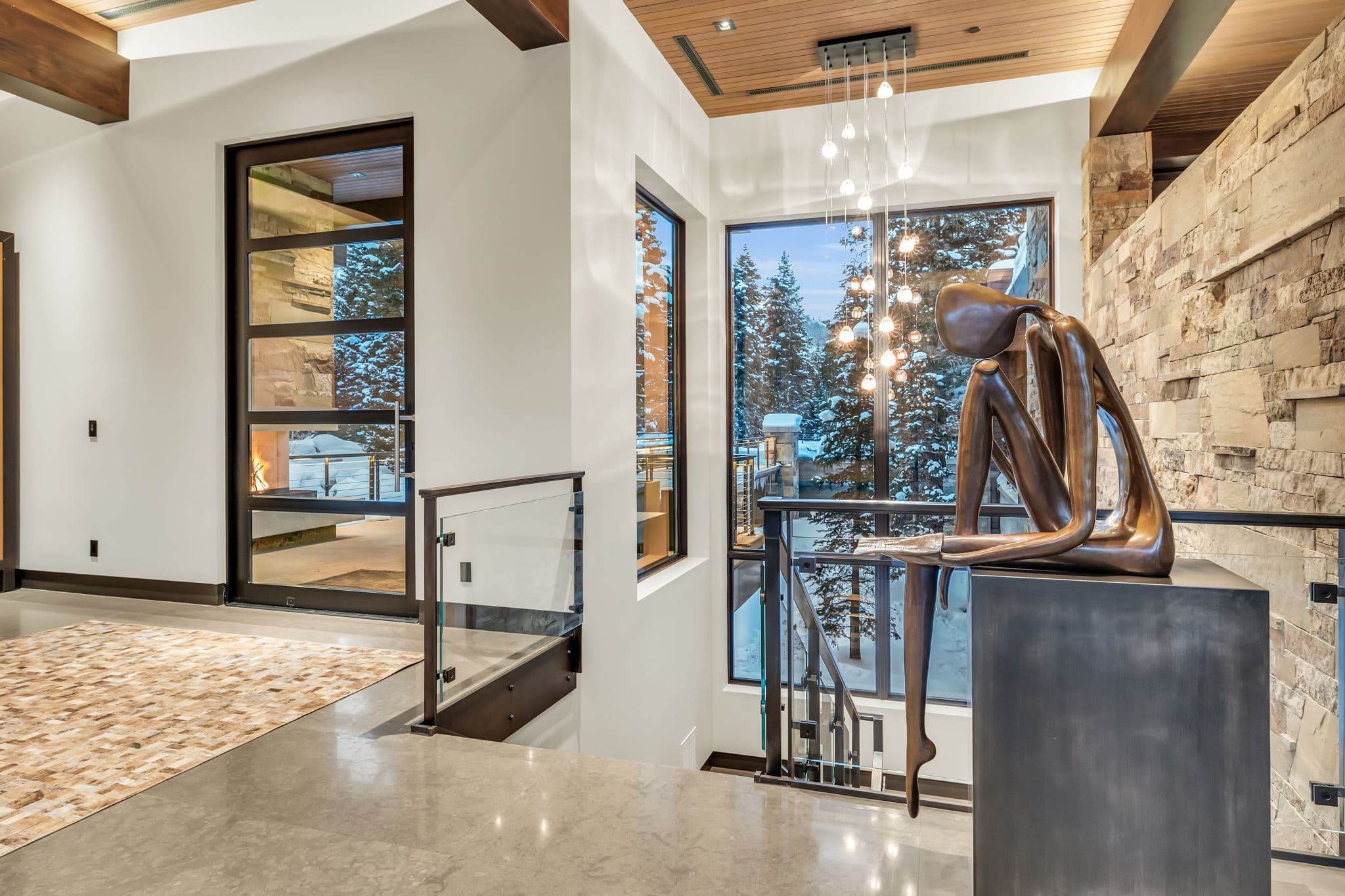 A stylish entryway with modern art and snowy views.