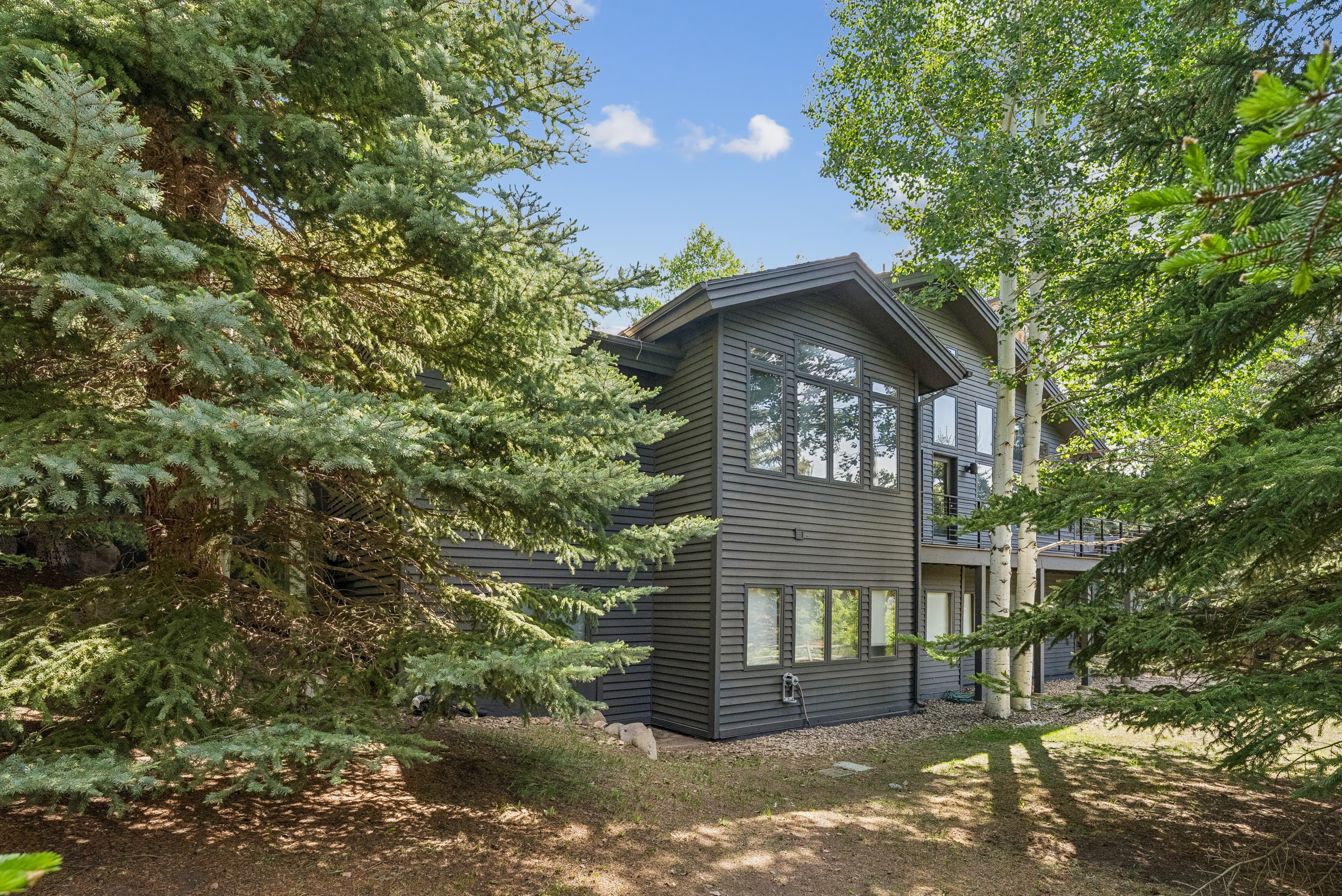 other side of the home with large windows facing the mountains