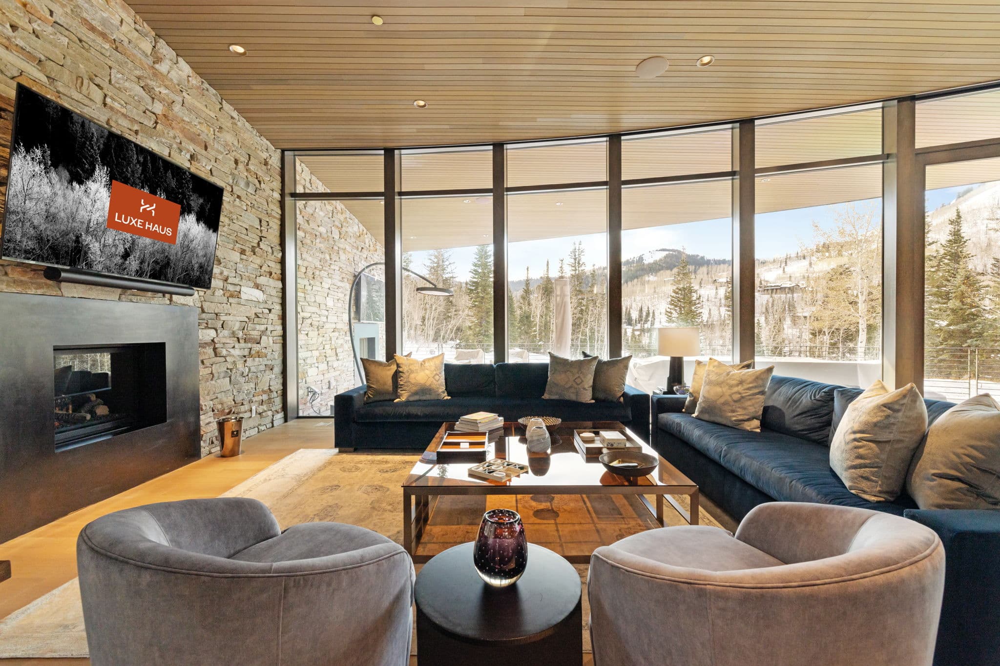A spacious living room with modern furnishings and a fireplace.
