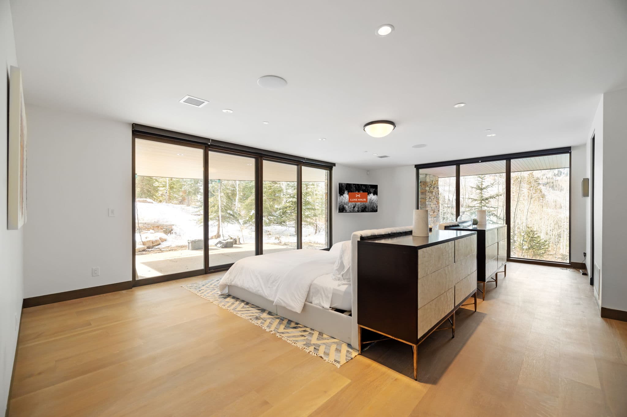 A large bedroom with two beds and a chest of drawers.