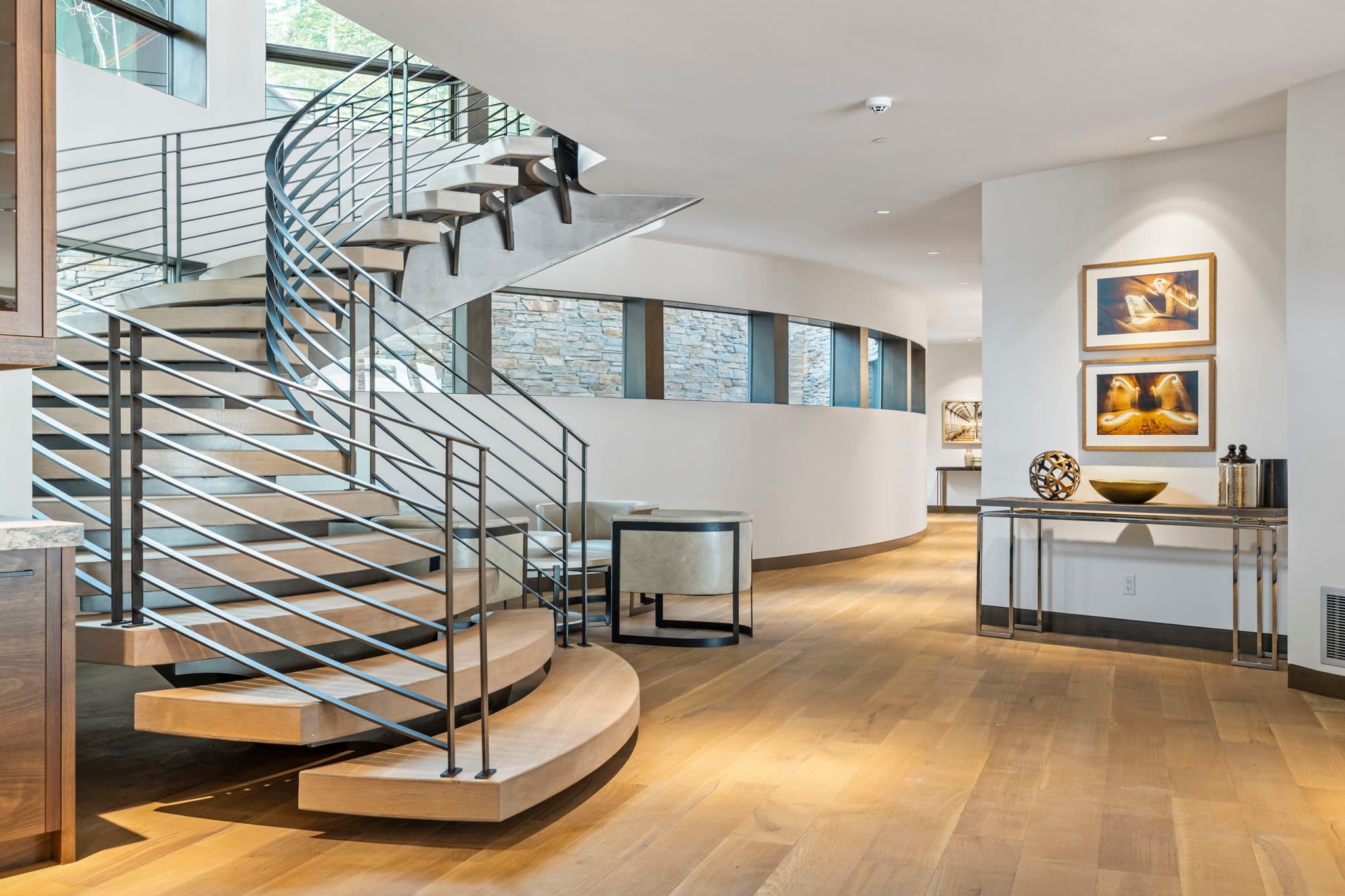 A view of a staircase and hallway with artwork on the wall.