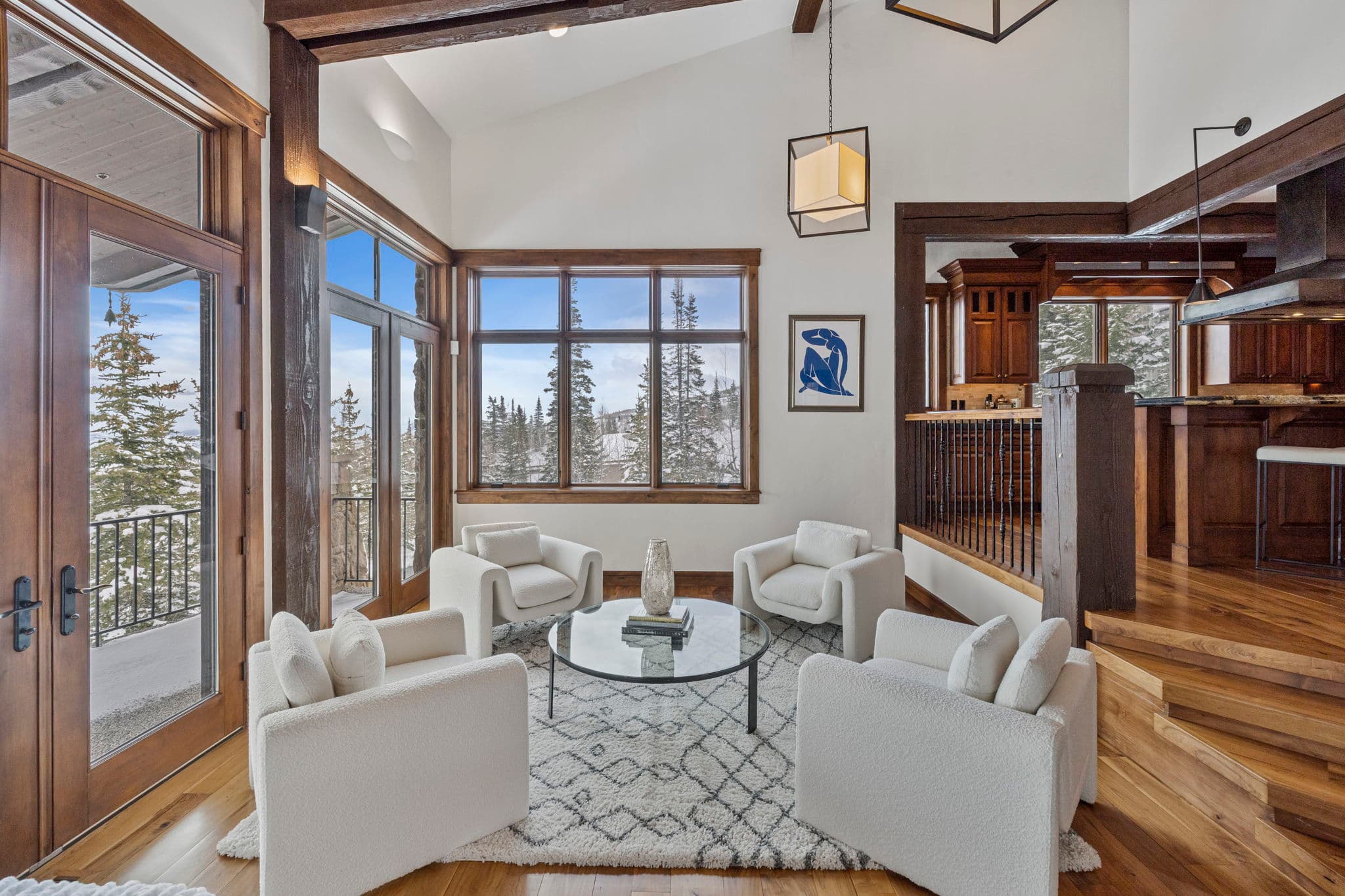 a view of the sitting area with overstuffed cream love seats and a view of the mountains outside of the windows