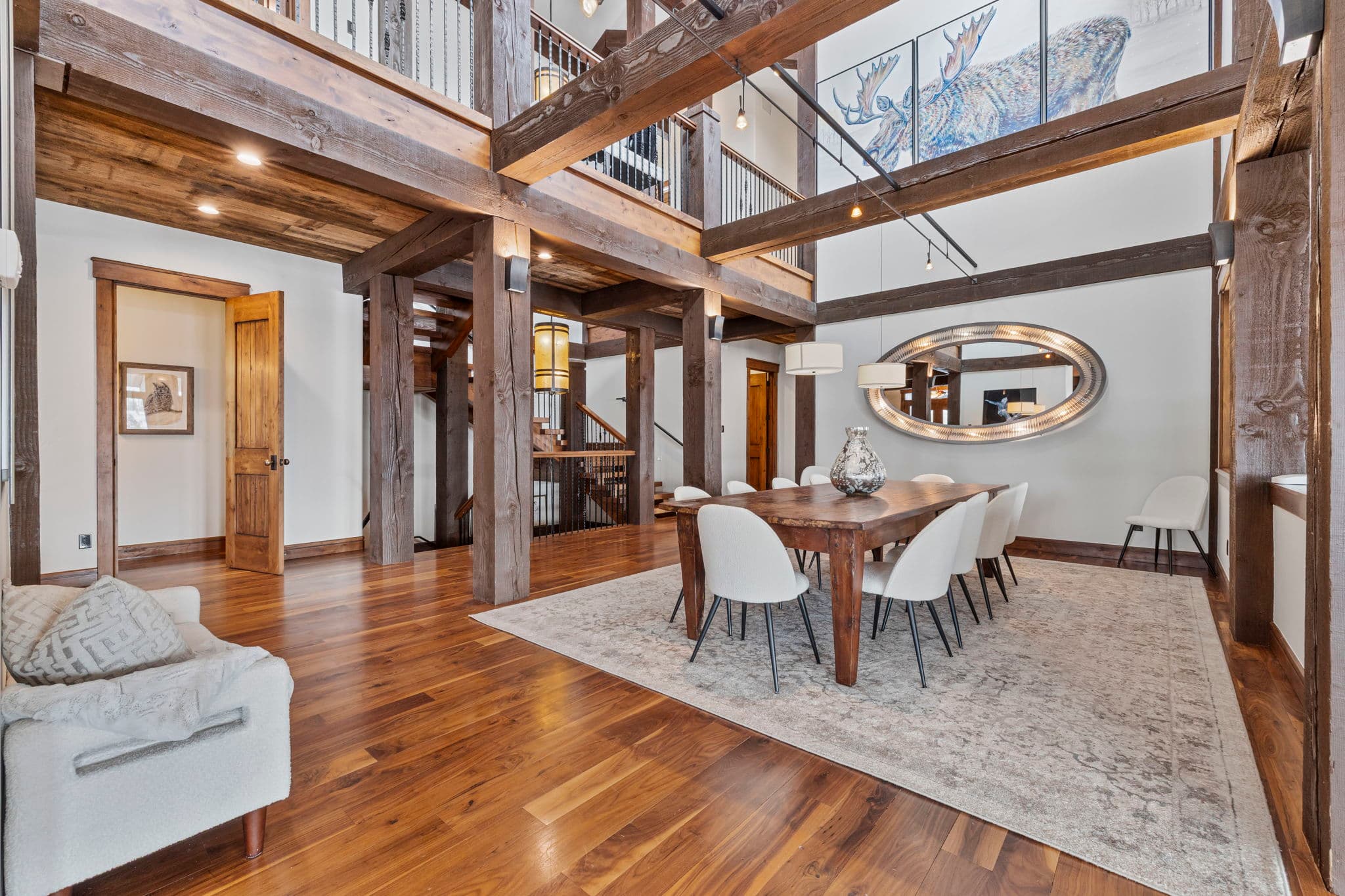a large dining room with tall ceilings and wood beams