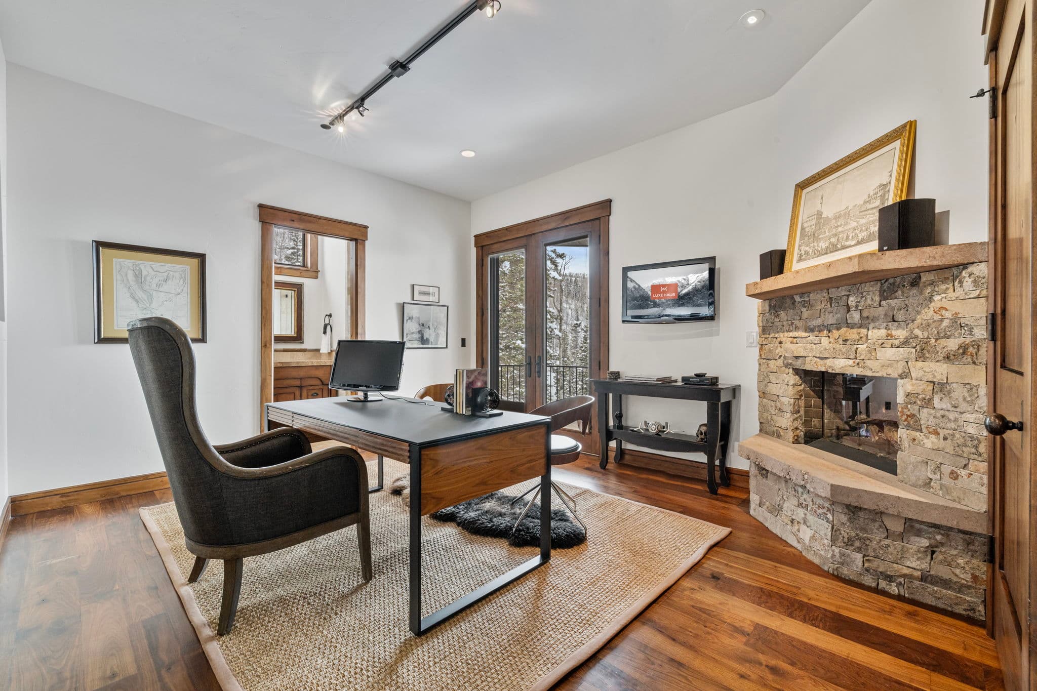 home office with stone fireplace and view of the mountains