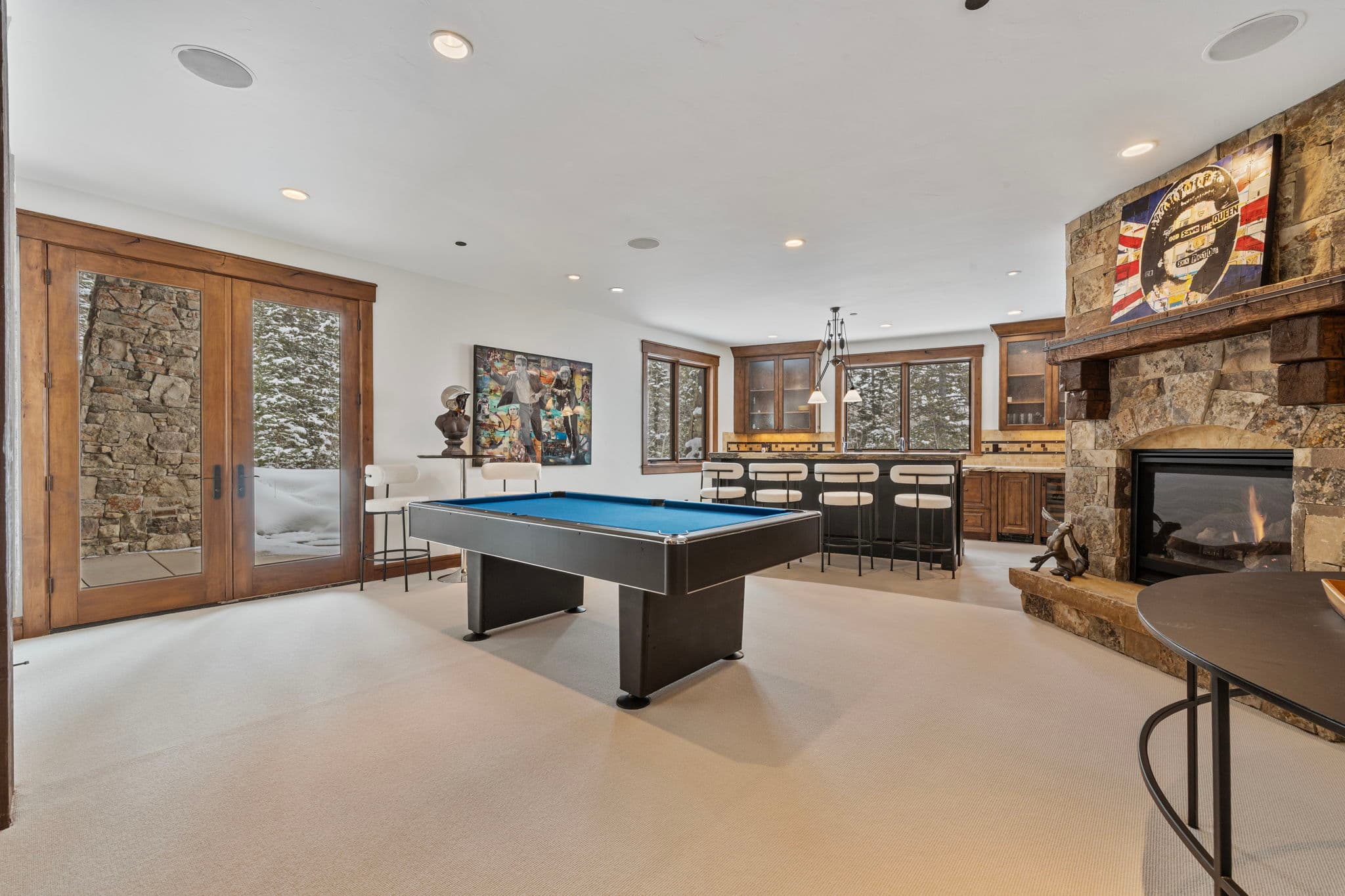 the game room with full bar, candy station, fireplace, pool table and views of the slopes